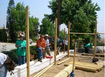 File:5 guys building a wood fence.jpg