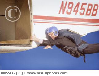 File:Business man hanging onto a plane 10055072.jpg