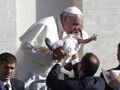 The Pope kisses another baby.