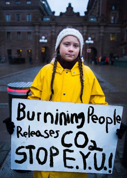 קובץ:גרטה תונברג אוחזת בשלט עליו כתוב “Burning People Releases CO2 STOP E.Y.U.!”.jpg