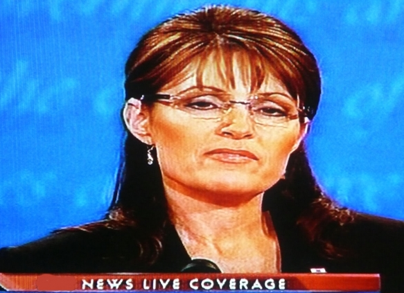 caption an image of Sarah Palin at the press conference, wow, she looks a lot like her down syndrome grand son Tri... oh I better watch myself if I don't want to end up with a lawsuit.