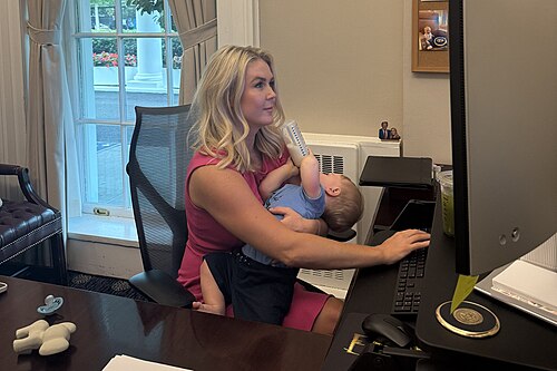 Karoline Leavitt feeding baby while working (cropped 2).jpg
