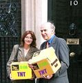 Vince Cable and a Lib Dem party member carrying some bombs.