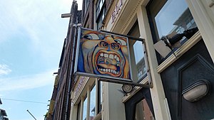 A sign with the cover art of The Court of the Crimson King painted on it.