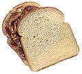 Peanut butter and jelly sandwich, top slice of bread turned clockwise to show the peanut butter and jelly filling.jpg