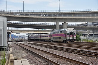 Outbound MBTA commuter rail train departing North Station July 2024.jpg