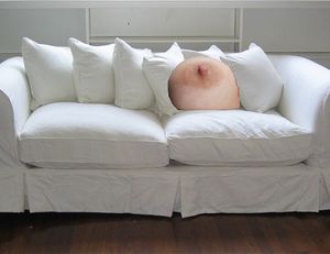 Nipples hidden in the sofa
